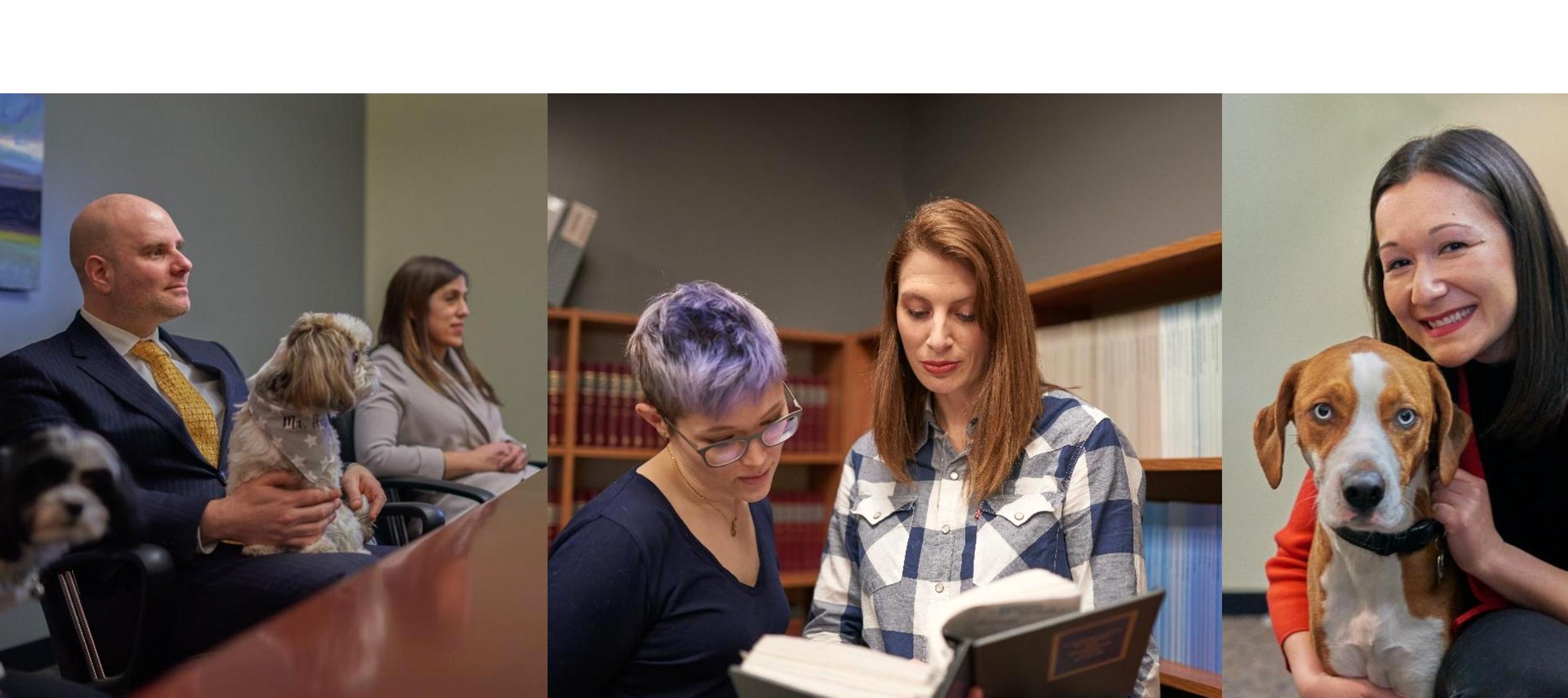 people and dogs sitting at a table, people looking at books, a woman with a dog