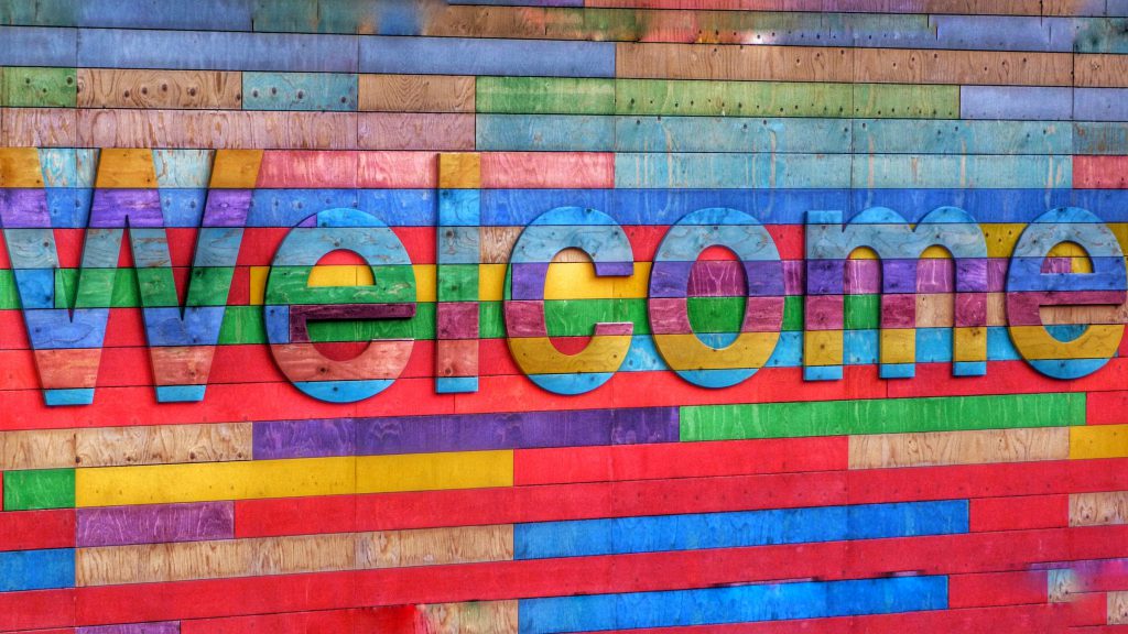 Colourful wall with a sign saying Welcome